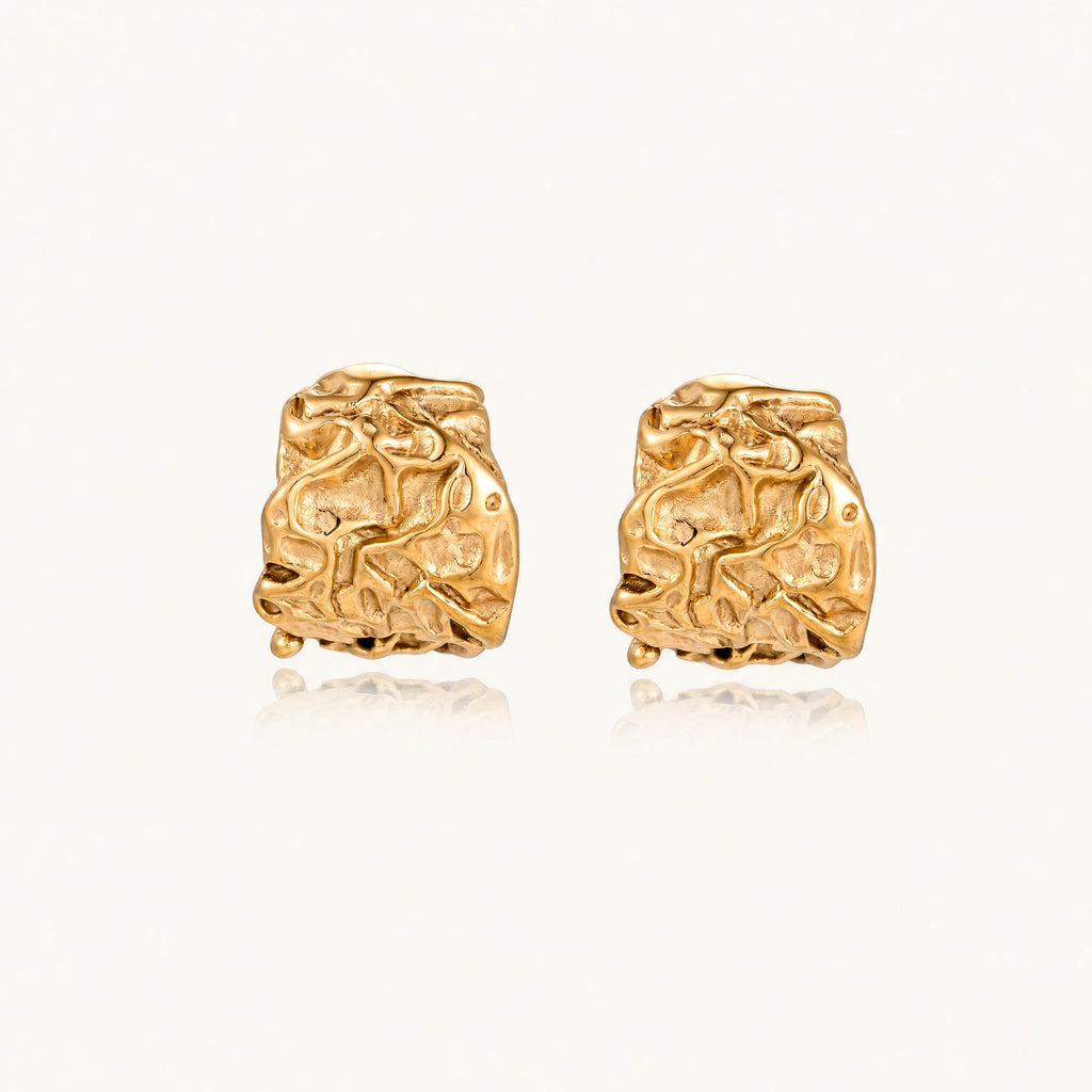 Chunky gold-plated hoop earrings with organic crumpled texture on cream background, 21.5mm sculptural design