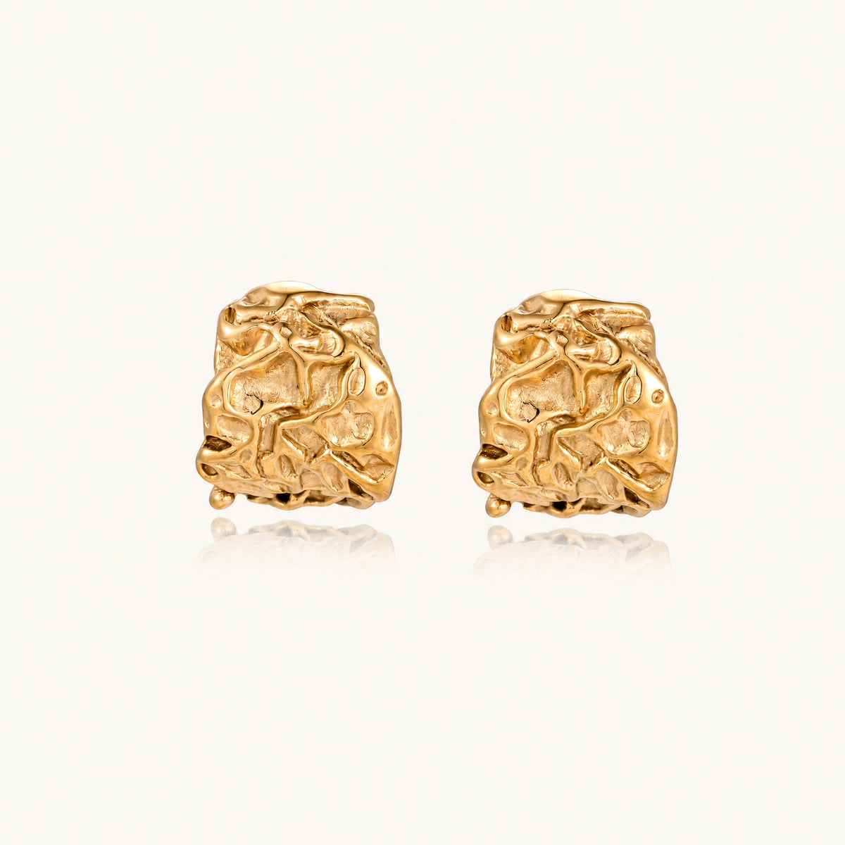 Chunky gold-plated hoop earrings with organic crumpled texture on cream background, 21.5mm sculptural design
