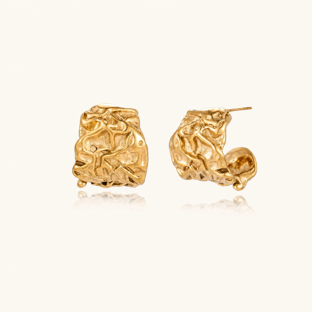 Chunky gold-plated hoop earrings with organic crumpled texture on cream background, 21.5mm sculptural design